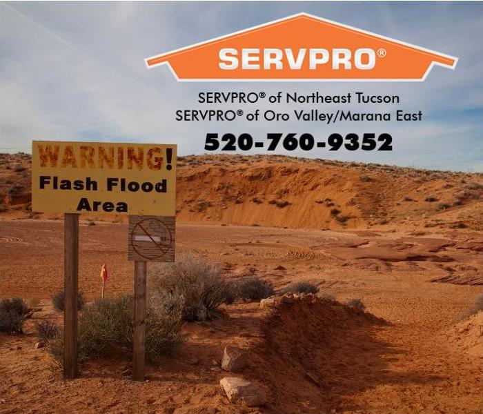 A Flash Flood Warning sign is posted next to a canyon in Arizona.