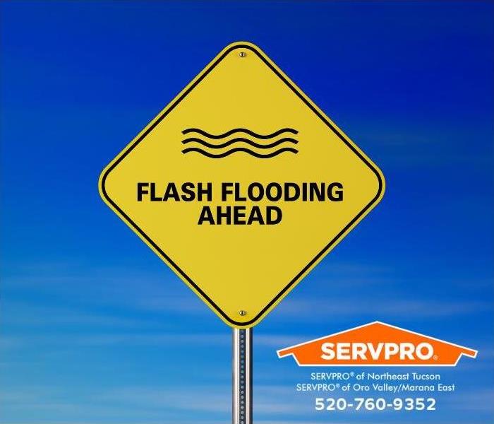 A sign reading “Flash Flooding Ahead” is shown.