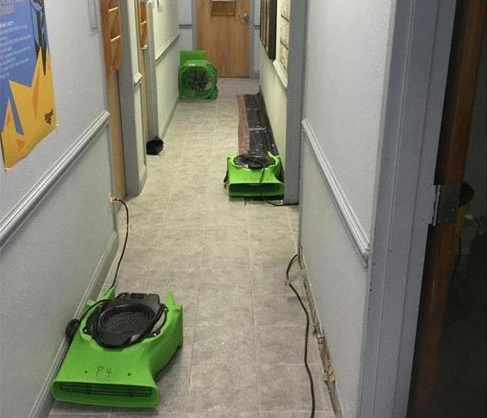Drying machines set up in a hallway to dry the carpet
